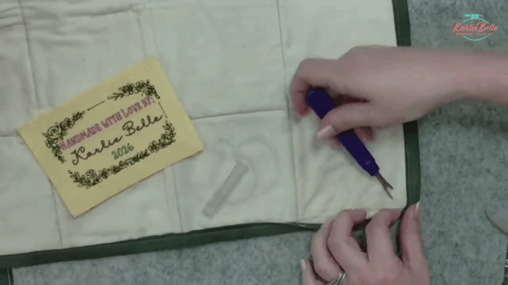 embroidered label sewn into quilt binding